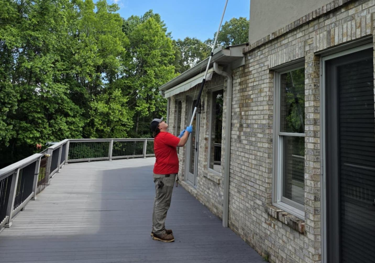 Critter Wranglers technician performing exterior spider treatment