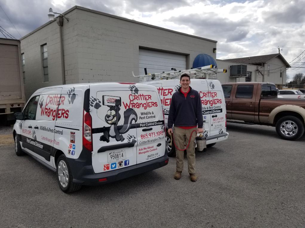 Critter Wranglers technician with service van