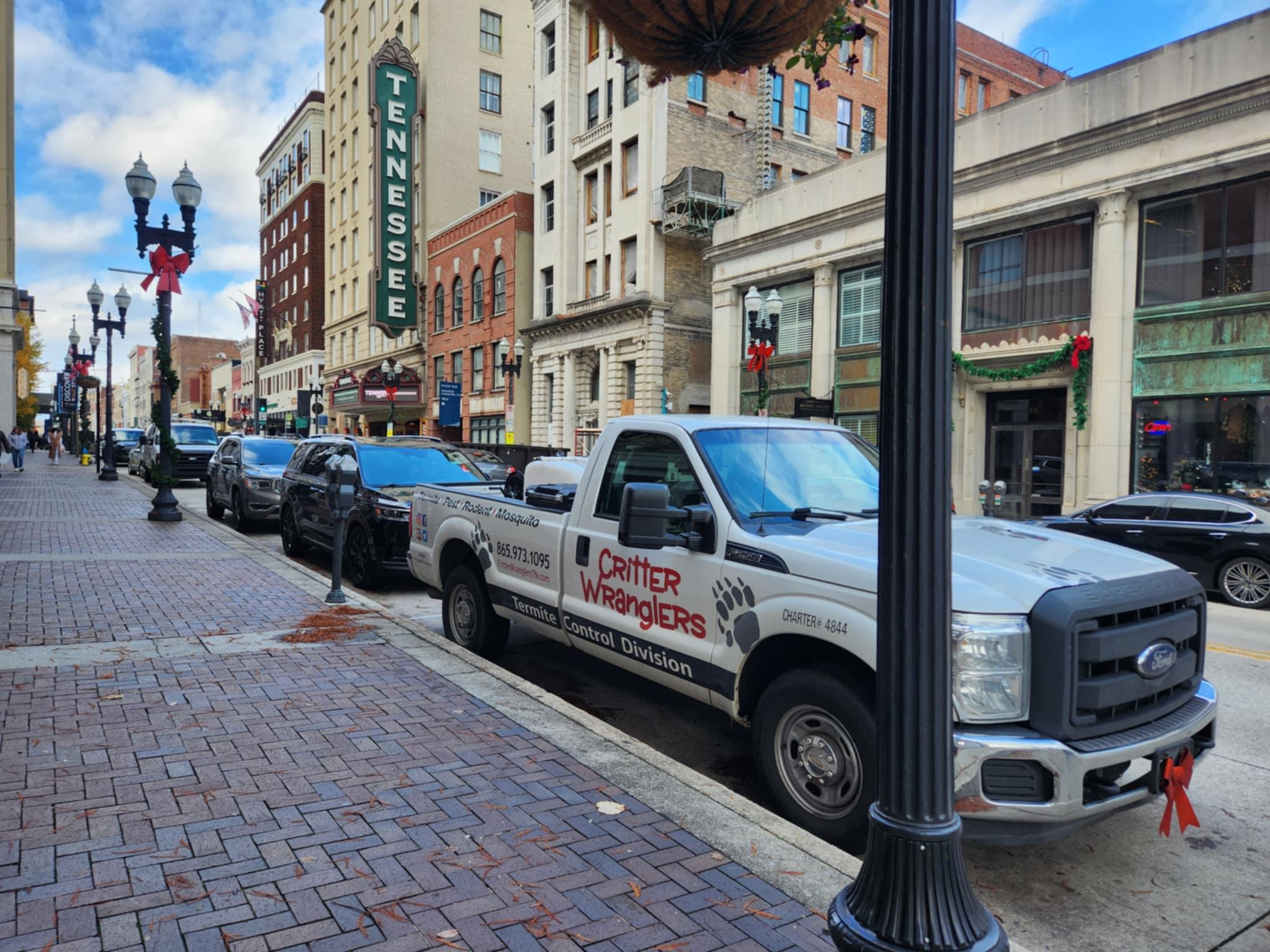 Critter Wranglers technician with service van